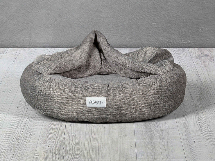 Grey Classic Cocoon Dog Bed with soft faux fur hood partially open by Collared Creatures